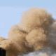 An image of smoke bellowing out of an industrial smoke stack