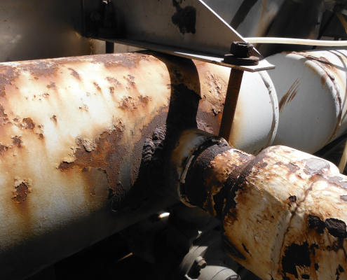 Rusty compressed air header in a dust collector