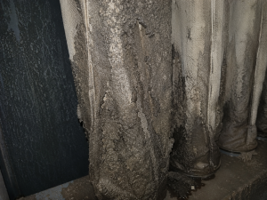 Close-up of industrial baghouse filter bags blinded by moisture and dust buildup caused by condensation inside a dust collection system.