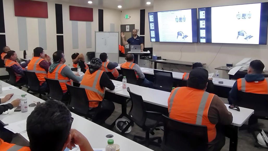 A maintenance team is receiving a class from a professional preventive maintenance specialist to evaluate equipment condition, identify developing problems, and support reliable baghouse operation.