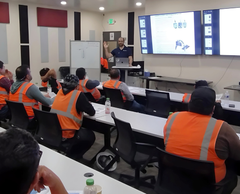 A maintenance team is receiving a class from a professional preventive maintenance specialist to evaluate equipment condition, identify developing problems, and support reliable baghouse operation.